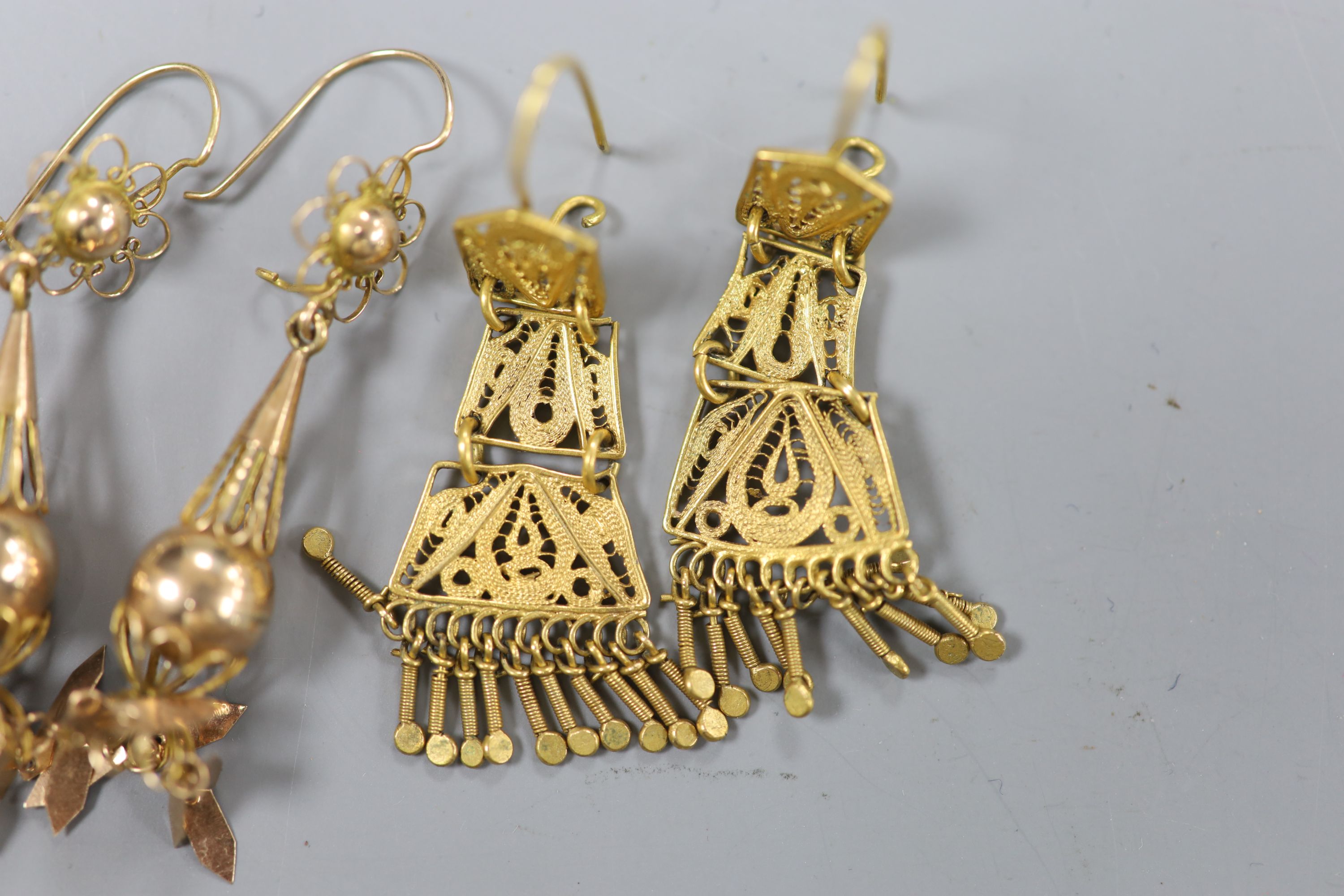 A pair of pierced yellow metal teardrop shaped drop earrings, overall 56mm, 2.8 grams & one other pair.